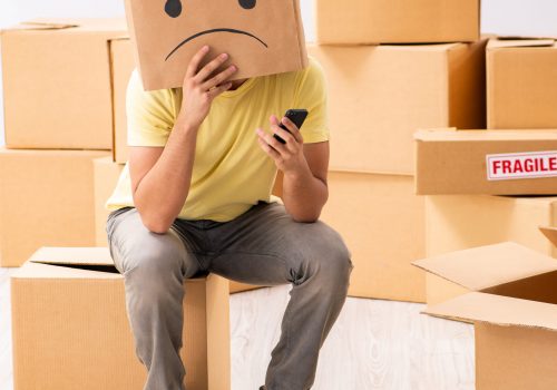 Unhappy man with box instead of his head